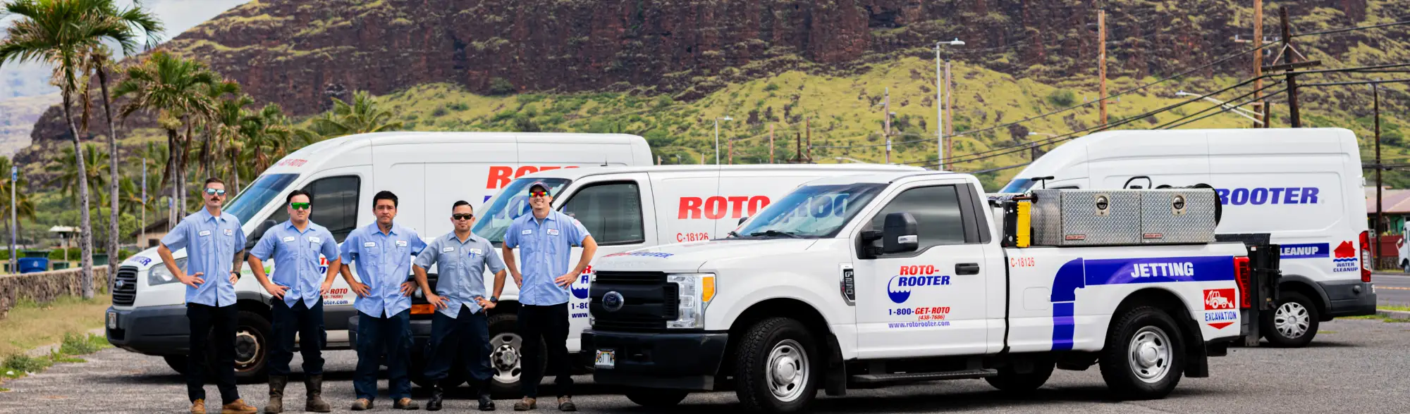 Several Redwire service vans lined up with techs in branded uniforms